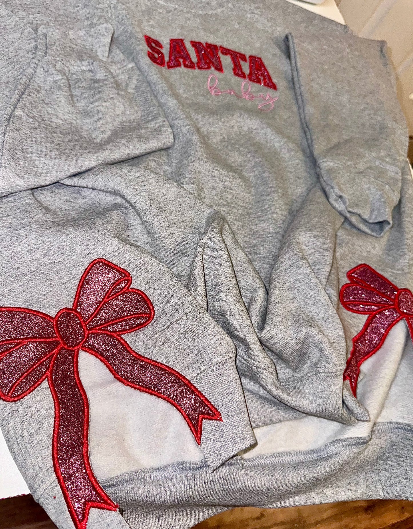 Embroidered glitter Santa Baby w/ added glitter side bows sweater top