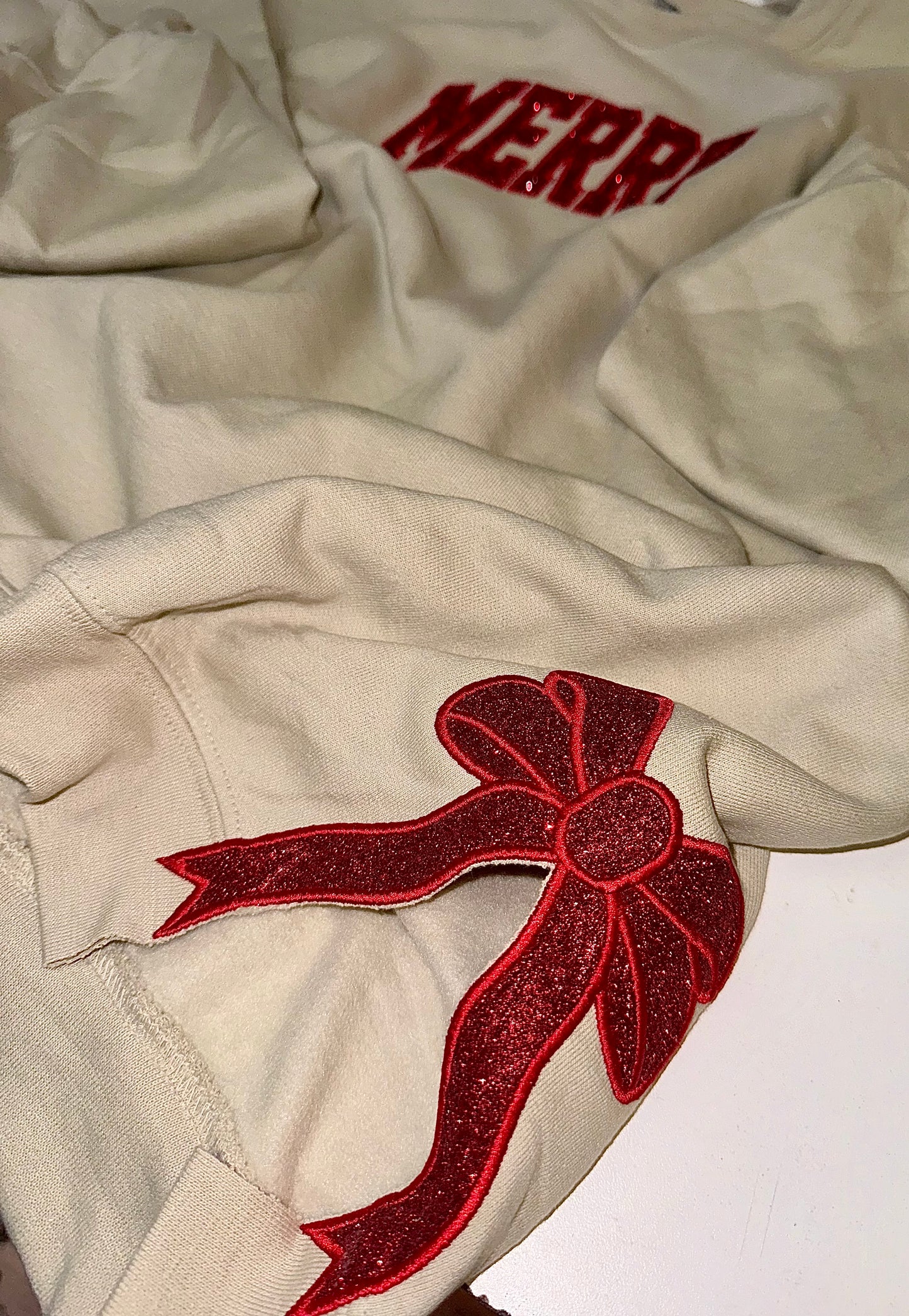 Embroidered glitter MERRY w/ added glitter side bows sweater top
