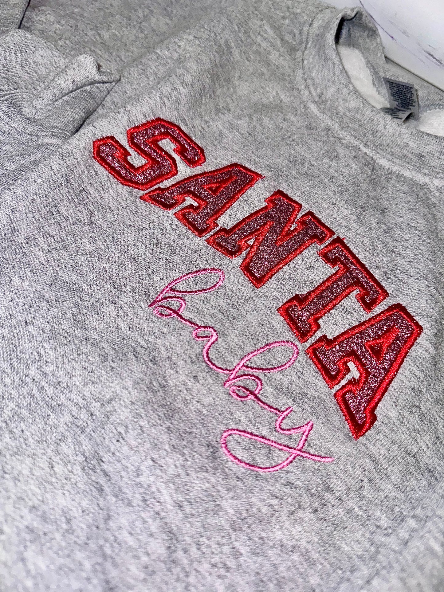 Embroidered glitter Santa Baby w/ added glitter side bows sweater top