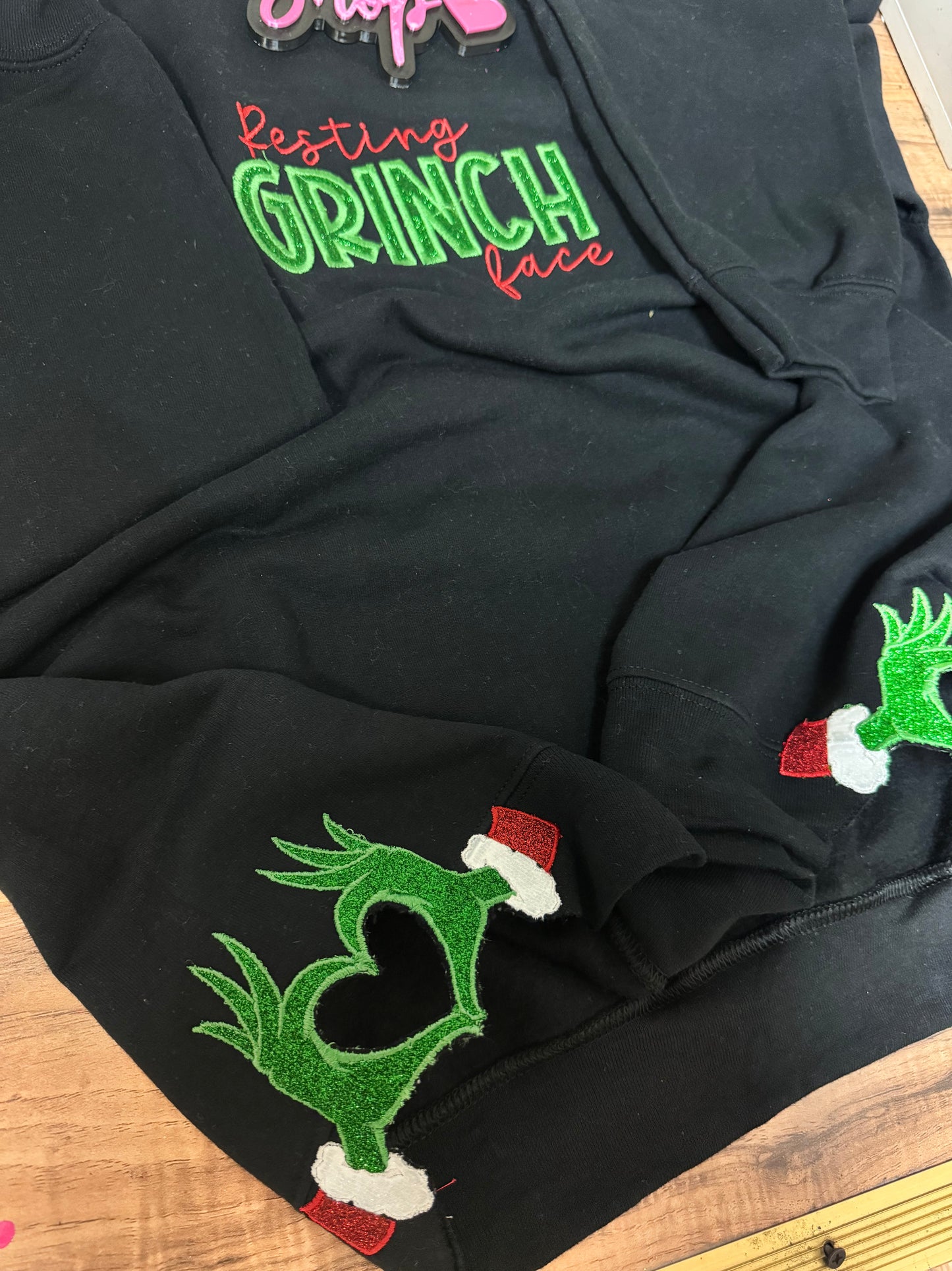 Embroidered resting grinch face w/ side hearts sweater
