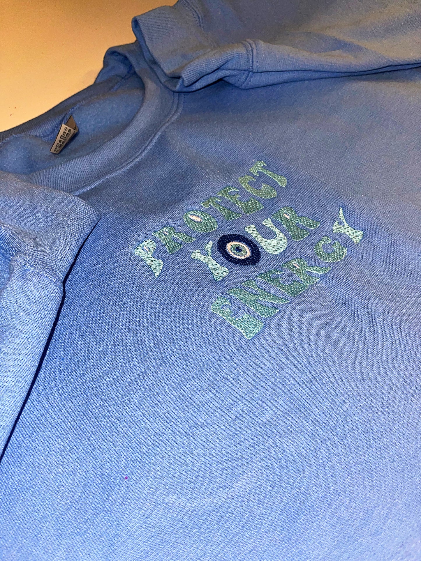 Protect your energy embroidered top