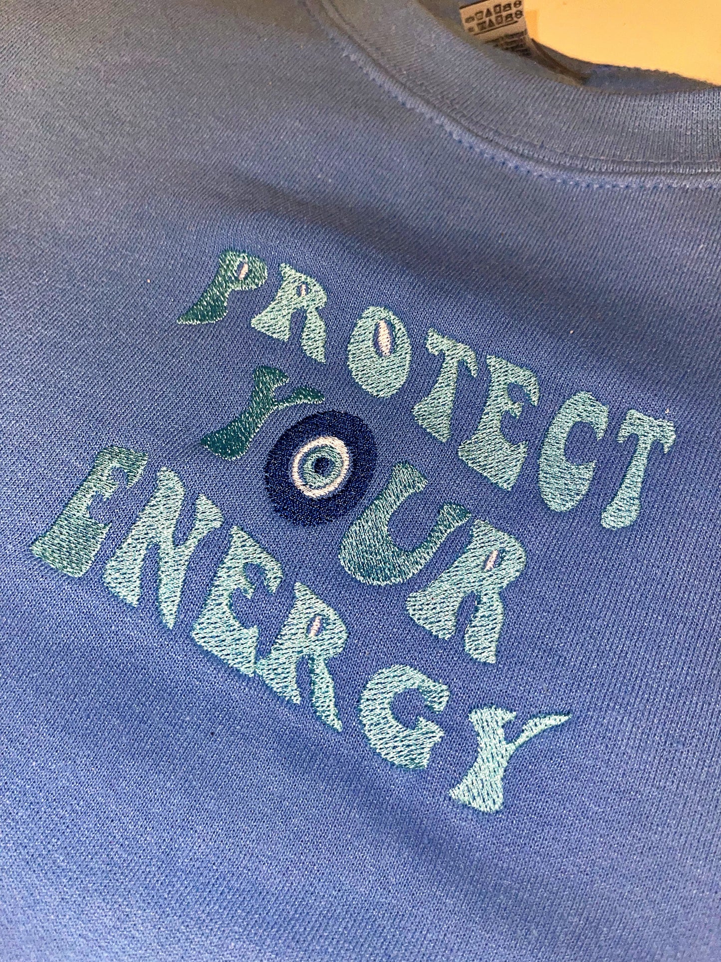 Protect your energy embroidered top