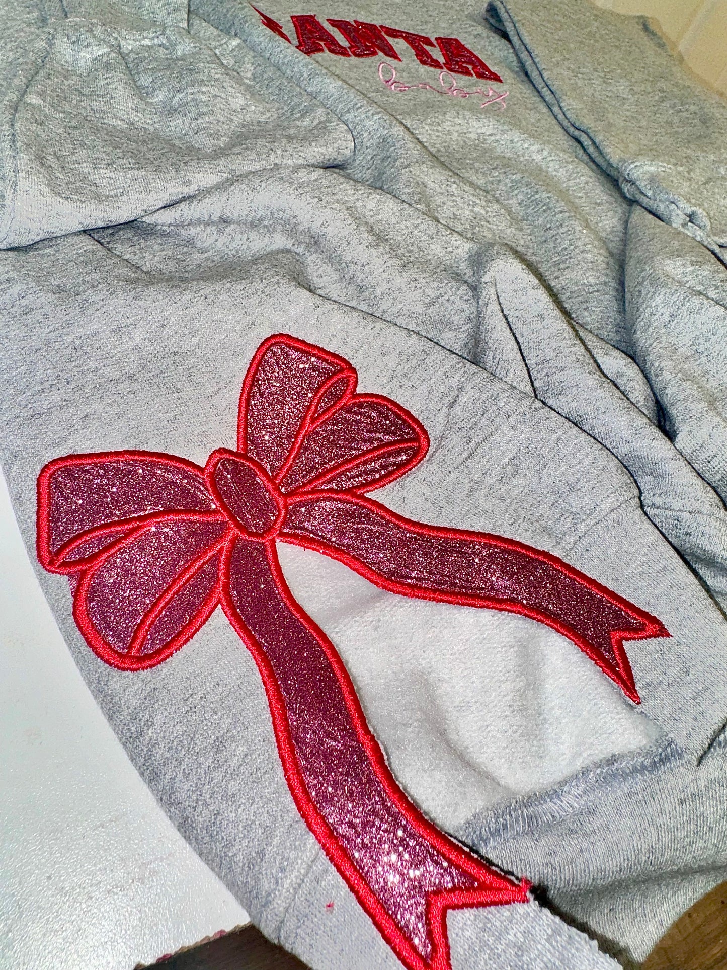 Embroidered glitter Santa Baby w/ added glitter side bows sweater top