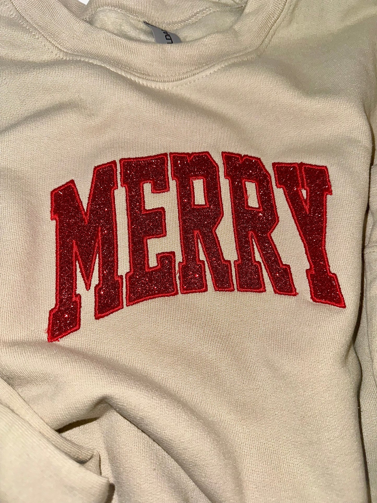 Embroidered glitter MERRY w/ added glitter side bows sweater top