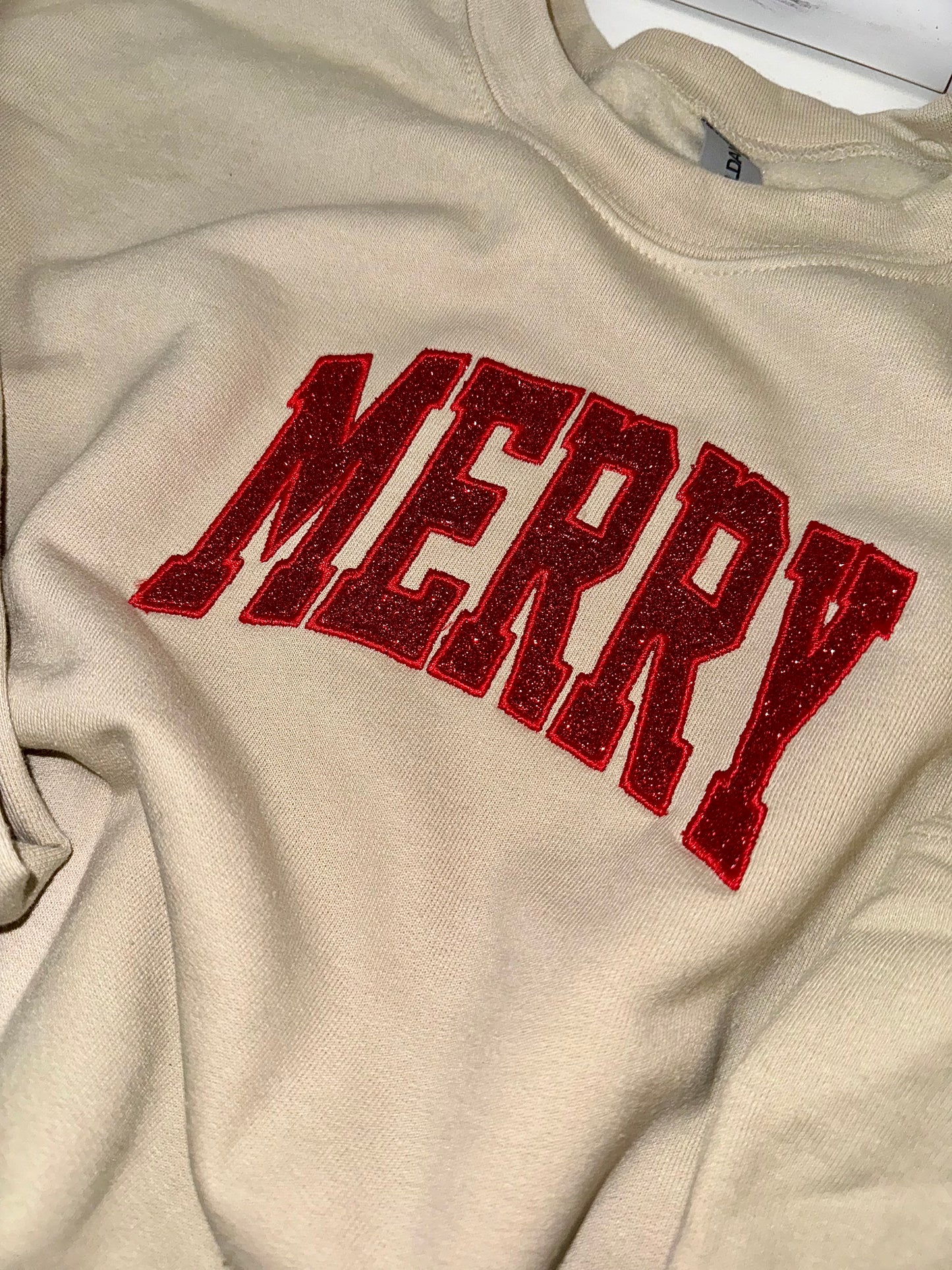 Embroidered glitter MERRY w/ added glitter side bows sweater top