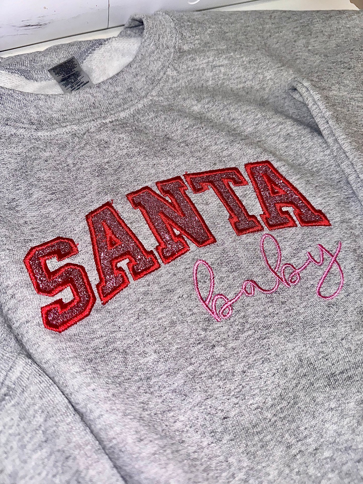 Embroidered glitter Santa Baby w/ added glitter side bows sweater top