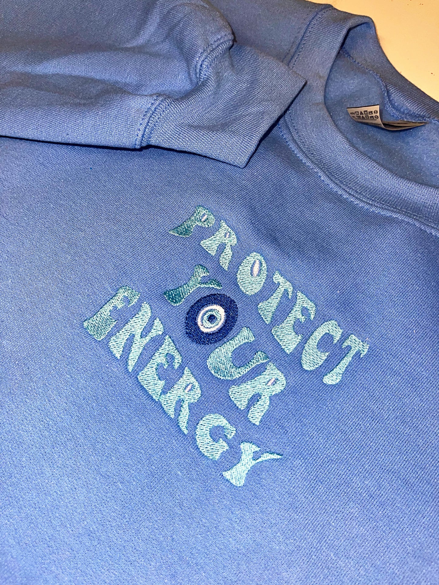 Protect your energy embroidered top