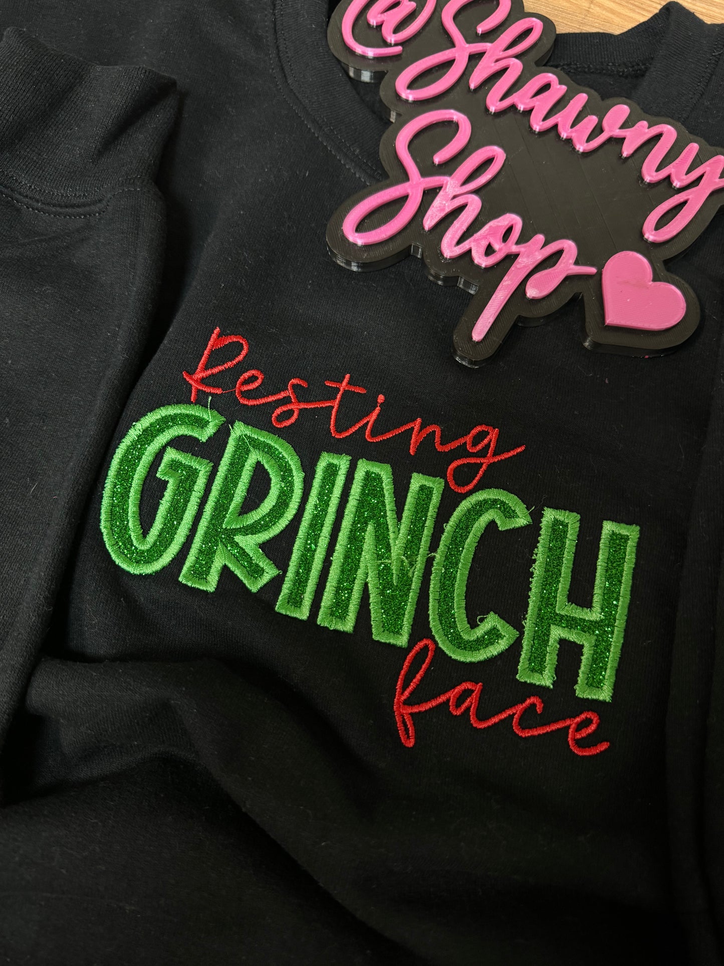 Embroidered resting grinch face w/ side hearts sweater