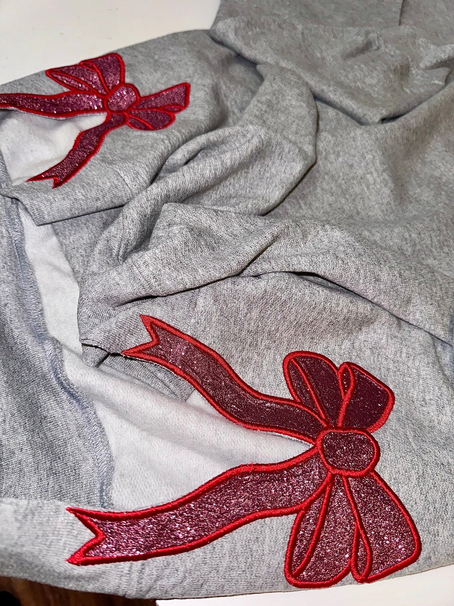Embroidered glitter Santa Baby w/ added glitter side bows sweater top