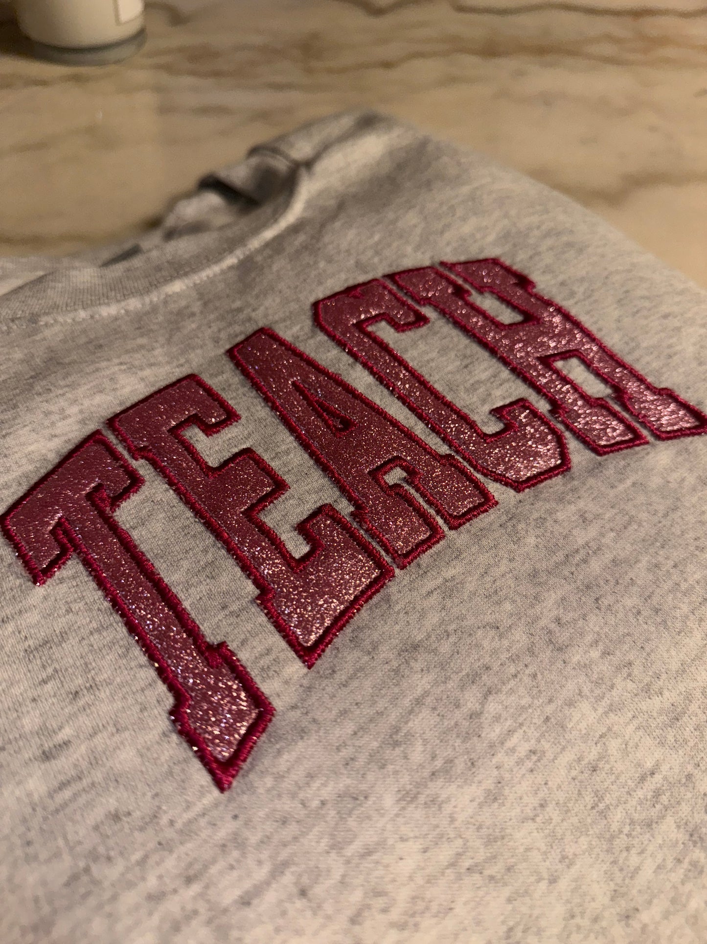 Embroidered glitter TEACH sweater top