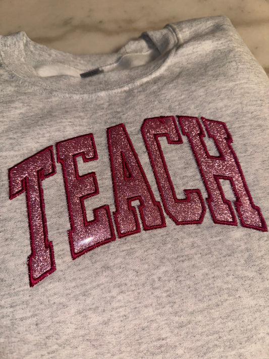 Embroidered glitter TEACH sweater top